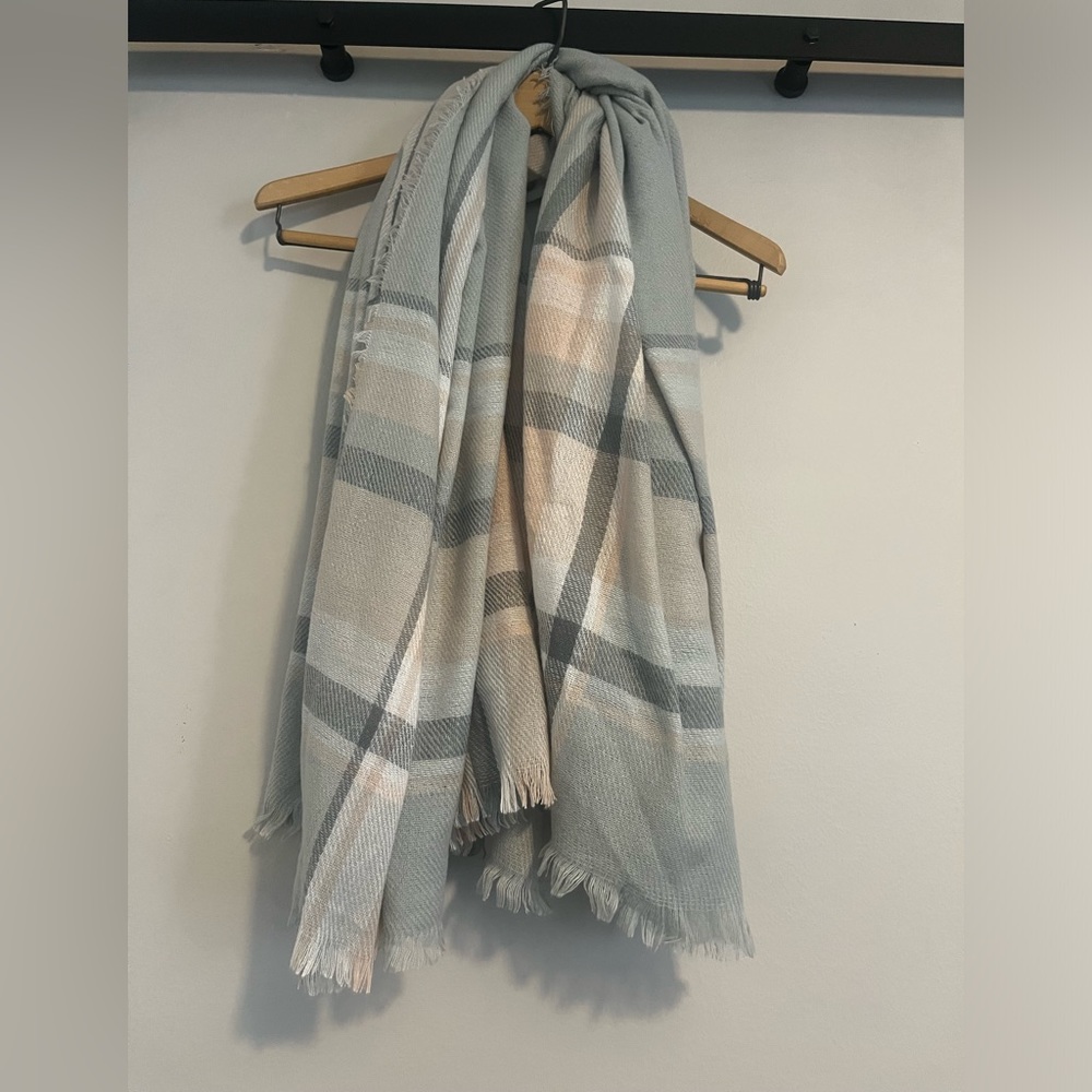 Blanket Scarf. Material feels acrylic. Pale pink, pale blue, light/dark gray.
